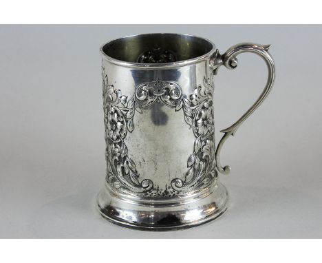 A Victorian silver mug, maker J R Sheffield 1839, with embossed floral decoration and two vacant cartouches and scroll handle