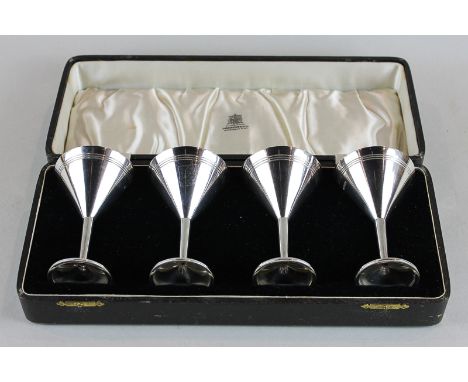 A set of four silver cocktails with cone shaped bowls and stemmed bases, maker J R Birmingham 1936, in case, 8oz