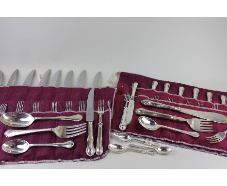 A silver canteen of flatware for twelve settings with scroll decorated handles, maker James Dixon and Sheffield 1976 and 1983