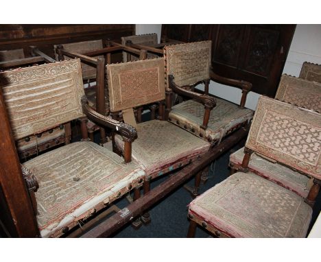 A set of twelve copies of Cromwellian dining chairs with tapestry back and seats and brass suds on turned legs joined by stre