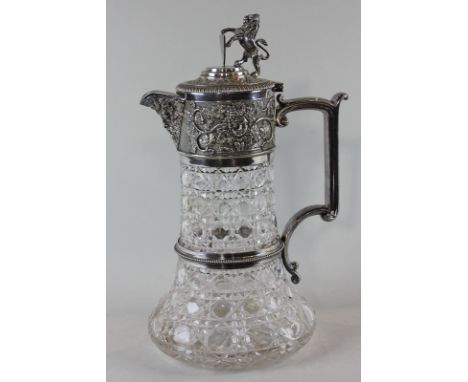 A late 19th, early 20th century Elkington plate mounted cut glass claret jug with lion and shield finial and mask and grape v