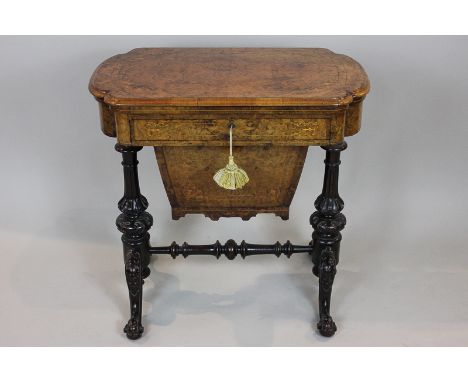 A mid Victorian figured walnut games and work table with folding chess board and backgammon and cribbage board top, with draw