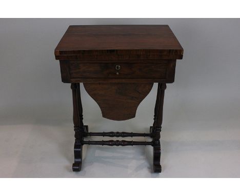 A Victorian rosewood games work table with rectangular rising top enclosing chess and backgammon boards, above drawer and sil