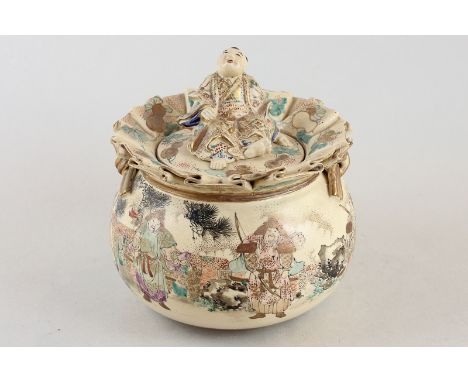 A 19th century Japanese satsuma pot and cover decorated with travellers and Samurai with seated figure finial to the cover