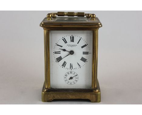 An early 20th century brass and bevelled glass case carriage clock with white enamelled dial signed Searle and Co Ltd Lombard