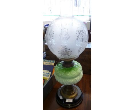 Victorian oil lamp having etched shade with moulded green glass reservoir on brass stem above ceramic base