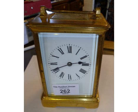 Brass carriage clock with enamel dial and striking on a gong, 5½ " tall