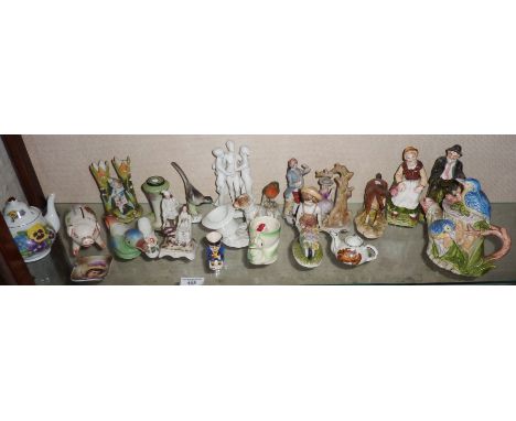 A shelf of assorted ornaments, inc. dog with top hat, posy vases, figures, etc.