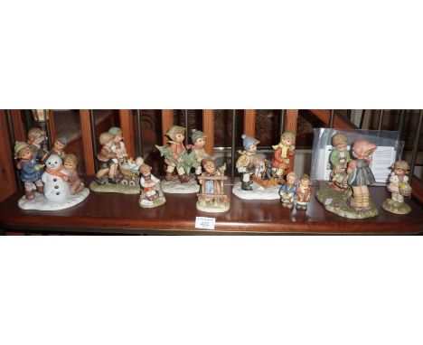 Shelf of Goebel Hummel children figurines and groups (10)