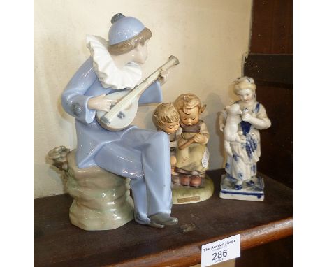 Nao china figure of a musician, a Goebels group "The Smart Little Sister" and a Continental blue and white figurine of a girl