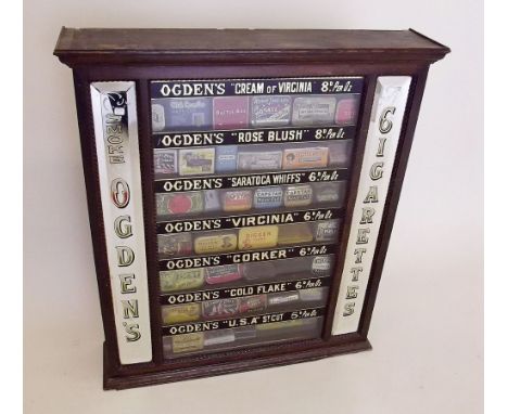 An Ogden's Limited tobacco shop display vending cabinet with mirrored sides, each shelf with painted brand labels and prices 