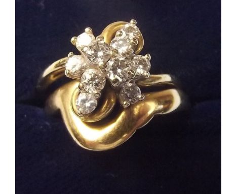 An 18 carat gold diamond cluster interlocking engagement ring and wedding band