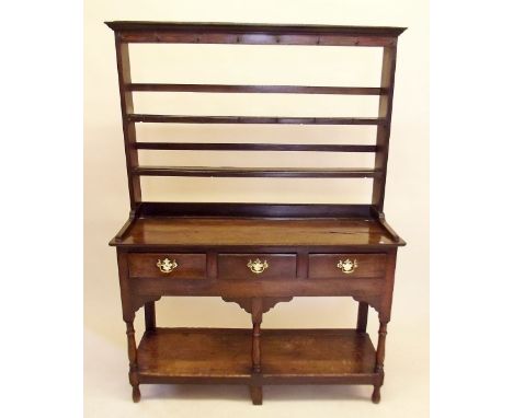 An 18th century oak Welsh dresser of small proportions, the open two tier back over three drawers and lower display shelf 124
