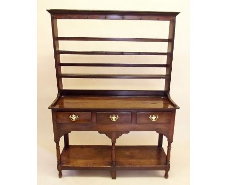 An 18th century oak Welsh dresser of small proportions, the open two tier back over three drawers and lower display shelf 124