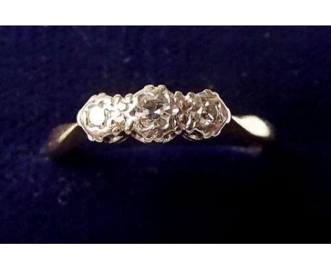 An 18 carat gold platinum set three stone diamond ring, size M