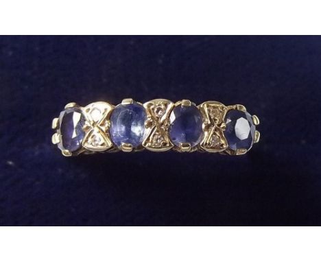 A 9 carat gold ring set four oval cut sapphires and six small diamonds - each sapphire 4mm x 3mm - with insurance valuation f