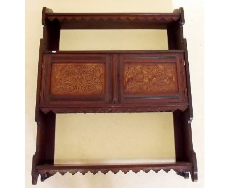 An Edwardian mahogany wall shelf with cabinet and carved decorations