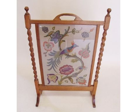 An early 20th century oak framed firescreen with crewel work and embroidered panel - 99cm