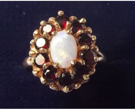 A 9 carat gold garnet and opal cluster ring - size K1/2