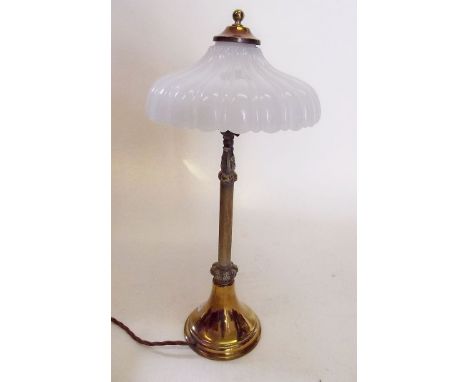 An Edwardian brass candlestick form table lamp with frilled glass shade