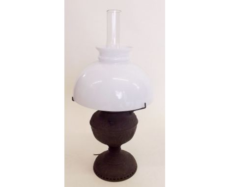 A Victorian embossed metal oil lamp and shade