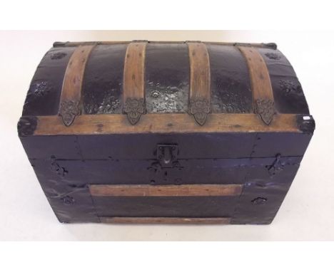 A wooden bound dome top trunk