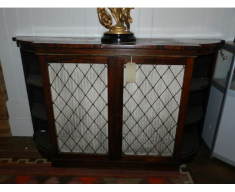 A Regency rosewood breakfront side cabinet, gilt metal mounted, fitted two brass lattice and pleated silk panelled cupboard d