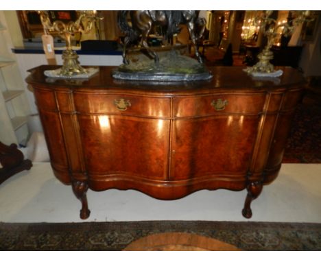 A Queen Anne style sideboard, by Charles Tozer, with a shaped bow front, the centre section with an arrangement of two drawer