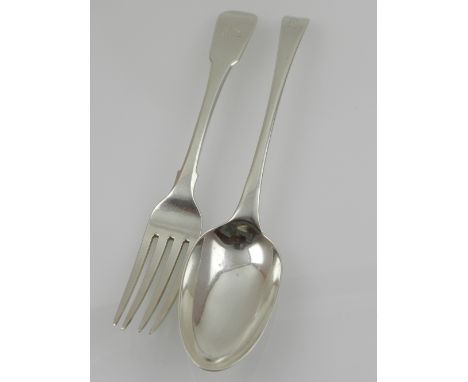 A 18th century silver serving spoon, bears indistinct hallmark for London, together with a silver dinner fork, hallmarked Lon