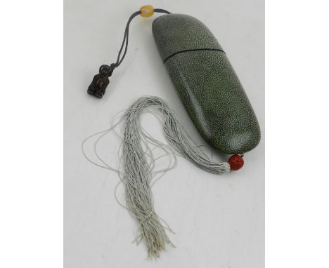 A Japanese shagreen case, of rounded rectangular form, with netsuke attached. L.19cm