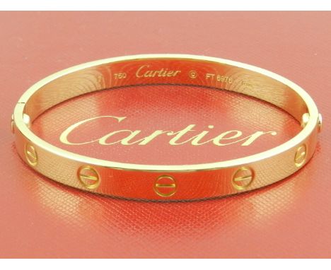 Cartier. An 18 carat yellow gold 'Love' bangle, with original box and paperwork. 