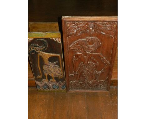 A 19th centrury Far East Asian wall panel, painted and carved with tribal figure, together with one similar wall panel 