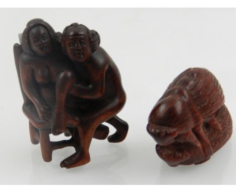 A carved horn netsuke, modelled in the form of two beetles, W. 5cm, together with a carved hardwood erotic netsuki, (2).   