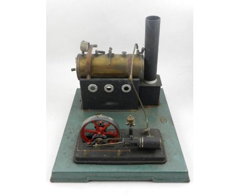 A Bing live steam static engine, circa 1930, the cylindrical brass boiler with pressure gauge, base W. 29cm.