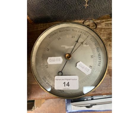A round brass cased aneroid barometer by John Bruce, Liverpool. 