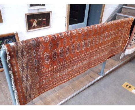 A vintage Bokhara style hand knotted wool carpet, red ground 188cn x 126cm (approx). 