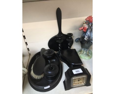 An ebonised and bakelite dressing table set including jewellery box and clock 