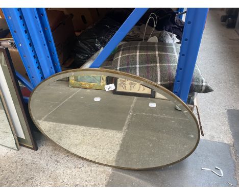 A vintage Ezeglide oval mirror with brass surround. 