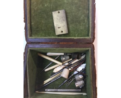 A sewing box with ornated copper top containing haberdashery items to include 2 Charles Horner silver timbles, number 8 and 9