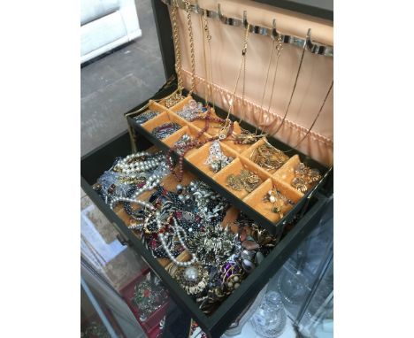 Green jewellery box containing quantity of costume jewellery including silver. 