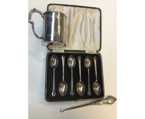 A boxed set of 6 silver spoons, a silver handled button hook and a silver "Graduation Day" mug. 