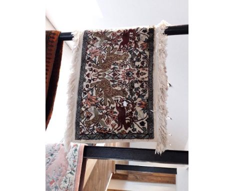 A Persian style carpet decorated with animals, 120cm x 50cm (approx), 