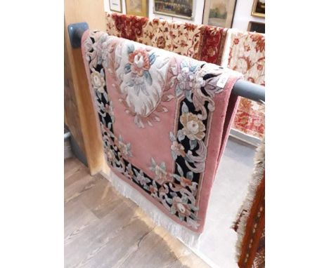 A Chinese wool carpet, pink ground 70cm x 130cm. 