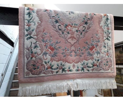 A Chinese wool carpet, pink ground 200cm x 122cm (approx) 