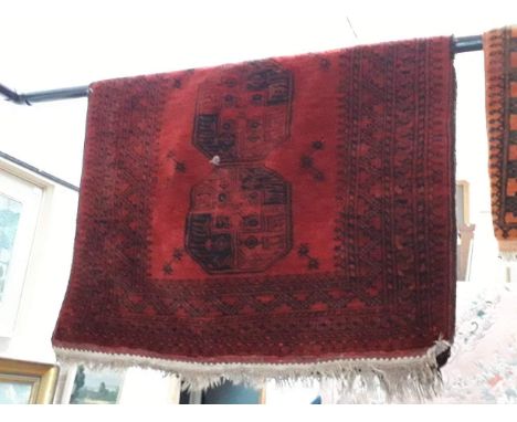 A vintage Eastern hand knotted wool carpet, red ground 190cm x 116cm (approx) 