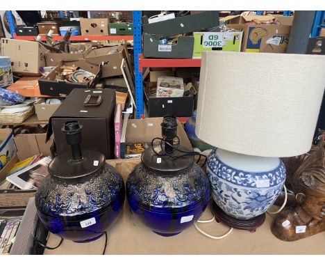A pair of large blue lamps and an Oriental style pottery lamp. 