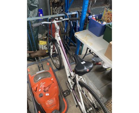 A Schwinn Seventh Avenue ladies bike with suspension fork, lights, 21 speed Shimano and foot stand. 
