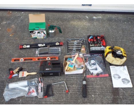 A mixed lot of tools to include a ratchet strap set, a box of new paint brushes, a McColock lawn mower engine and similar.