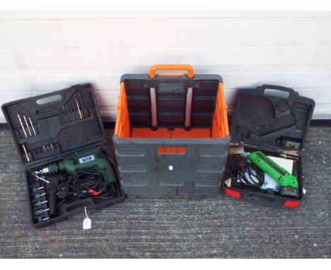 A TCL Impact Power Drill with accessories, cased, an Exakt PS-140 Precision power saw with accessories, cased and a folding t