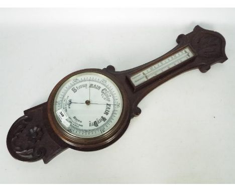 An oak banjo barometer with carved decoration, approximately 81 cm (l)